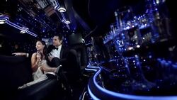 Hollywood couple in limousine wave at paparazzi and clink champagne glasses at awards show Stock Footage