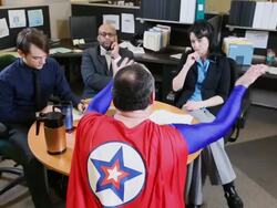 MS PAN Three business people Sitting at round table in office space are lecture by superhero in red cape / Seattle, Washington, United States  Stock Footage