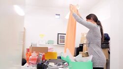 Fashion buyer wrapping skirt box in messy office Stock Footage
