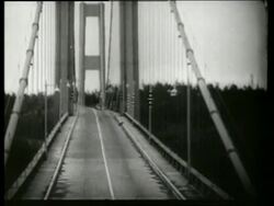 B/W 1940's bridge twisting, swaying + buckling in wind / Galloping Gertie / Tacoma Narrows Bridge / Stock Footage