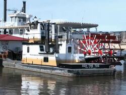 Two old fashioned boats sit docked on the Mississippi River in St. Paul Minnesota Stock Footage