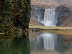 MS Shot of Skogafoss Falls which reflected in lagoon / Iceland Stock Footage