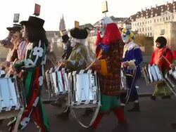 MS PAN Shot of people with mask and dressing up playing drums celebrating Basler Fasnacht (Basel Carnival) on street / Basel, Switzerland Stock Footage