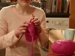CU TU Shot of Woman knitting sitting at kitchen table / London, Greater London, United Kingdom Stock Footage