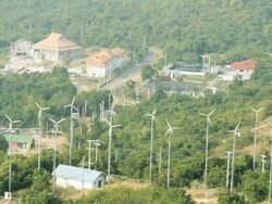 Village And Wind Turbine Timelapse Stock Footage