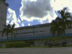 CU SUV driving away/ MS Luggage cart driving past Toussaint Louverture Airport/ Port-au-Prince Stock Footage