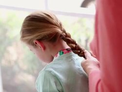 CU Mother braiding her daughter's hair / St. Simon's Island, Georgia, United States Stock Footage