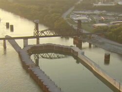 WS AERIAL View of old railroad drawbridge and powerlines crossing Tennessee River / Chattanooga, Tennessee, United States Stock Footage