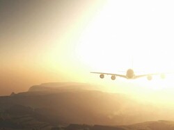 Airplane Flying at Sunset Stock Footage