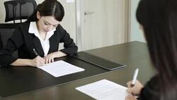 Two Business women hands writing sign up contract Stock Footage