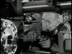 1944: JONES & LAMSON MACHINE CO.: MS Factory worker operating machine. MS Man turning crank, tightening bolt in machine. VS Two executives looking over paper work at desk in office. Springfield, Vermont. Instructional Video
