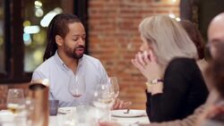 MS Smiling man in discussion with friend during dinner party Stock Footage