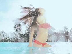HD SUPER SLOW-MO: Woman Flipping Hair In The Pool Stock Footage