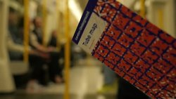 Commuter Reading Tube Map On London Underground Train News Clip