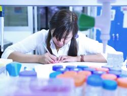 Scientist writing notebook in laboratory Stock Footage