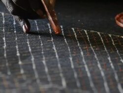 CU Woman using carved wooden comb to create abstract tiwi art / Northern Territory, Australia Stock Footage