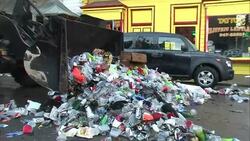 A city maintenance crew scoops all kinds of trash from a street in New Orleans. Stock Footage