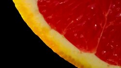 Close up of healthy blood orange slowly rotating Black background Stock Footage