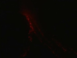 Red hot glowing lava cascades down the side of erupting volcano at night, Philippines, Dec 2009 Stock Footage