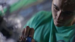 Bicycle mechanic tightens spinning wheel with screwdriver in bike repair shop Stock Footage