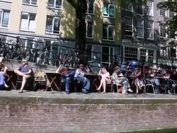 WS POV People sitting at open cafe near canal / Amsterdam, The Netherlands, Holland Stock Footage