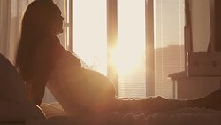 Pregnant woman in bed Stock Footage