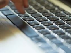Hand typing a laptop computer Stock Footage