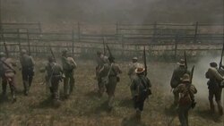 Confederate soldiers flee across a field and climb over a fence during a Civil War battle. Stock Footage