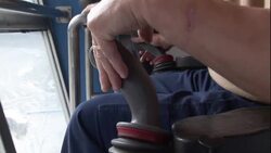 A man operates a joystick on large mining machinery. Stock Footage
