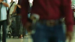 Crowd of travelers at airport terminal check-in area Stock Footage