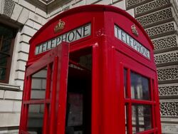 Close up of red phone booth, pan to right to long Stock Footage