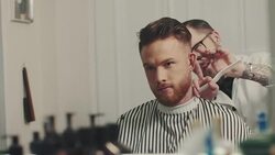 Barber cutting a mans hair Stock Footage