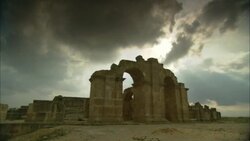 Storm clouds loom over an archway at Uthina Amphitheater in Tunisia. Stock Footage