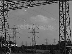 1947: CLEVELAND ELECTRIC POWER: OHIO: WS Electric power transmission lines. WS Power generator grid. WS Various materials superimposed over power lines, 'Plywood, aluminum, glass, plastics, bronze, brass.' Consumption, alternative energy, OH Instructional Video