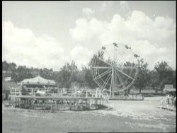 Girls ride a Ferris wheel at an amusement park in Oak Ridge, Tennessee. News Clip