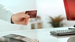 Man giving his credit card to salesperson behind the counter Stock Footage