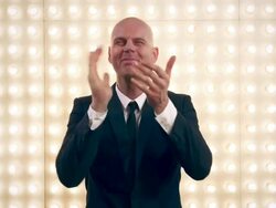 Man applauding in front of lightwall Stock Footage