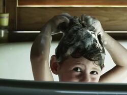 CU Girl (2-3) washing hair in bathtub, American Fork, Utah, USA Stock Footage