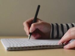 Woman writing notes in textbook at office desk. Stock Footage