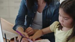 Working mom helping daughter to color page Stock Footage