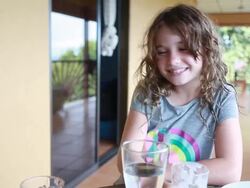 Girl spits milk into glass and boy adds the milk to his recipe. Stock Footage