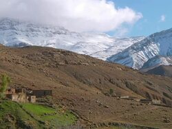 WS View of small home at mountain base with clouds rolling over atlas mountains / Marrakech, Tensift, Morocco  Stock Footage