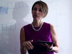 CU PAN TU R/F Mature businesswoman standing holding digital tablet in discussion with coworkers at whiteboard/Washington, USA Stock Footage