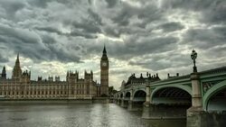 Ominous clouds drift above Big Ben, the Houses of Parliament and the Tower Bridge in London. Stock Footage
