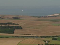 LOW AERIAL, Fields along shoreline, Sangatte, Pas de Calais, France Stock Footage