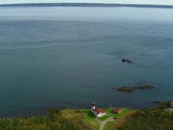 WS ARIEAL DS View of West Quoddy Head Lighthouse at sea coast / Maine, United States Stock Footage