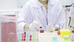 Girl in a laboratory pipette filled with sample. Stock Footage