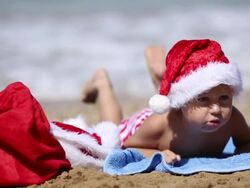 Baby in Santa Claus hat on the beach Stock Footage