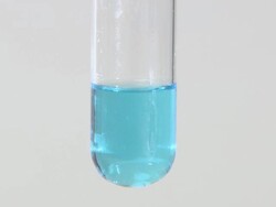 Copper (II) hydroxide precipitate, formed as sodium hydroxide is dripped into copper (II) sulphate solution Stock Footage