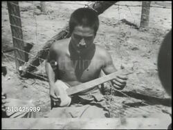 1943: BOUGAINVILLE CAMPAIGN: VS Japanese prisoners of war (POW) in camp, playing card game, playing makeshift banjo, new POWs registering, bowing to U.S. officers. WWII, World War II, Pacific Front, POW camp Instructional Video